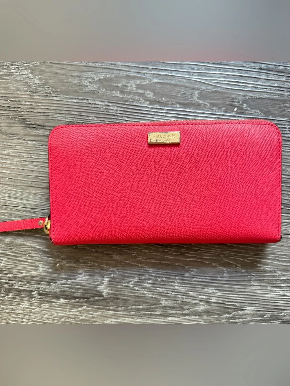 kate spade bright red zip-around Saffiano leather wallet with gold plaque